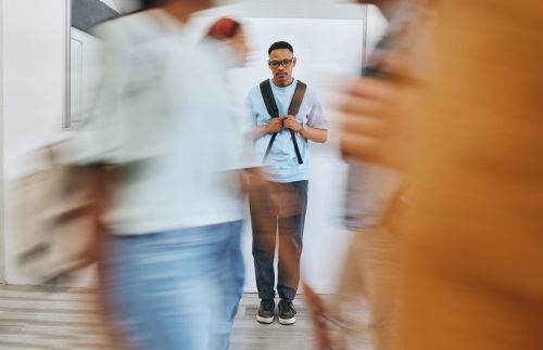 Sad student walking through school hallway