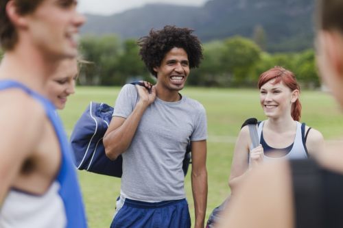 Runners talking in park